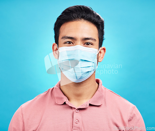 Image of Man in face mask, portrait and covid with safety from virus, bacteria and germs isolated on blue background. Disease, corona and male person, health compliance and rules with protection in studio