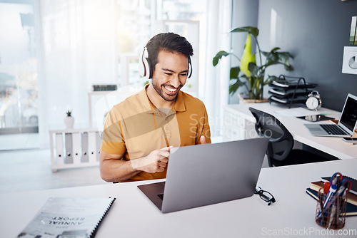 Image of Business man, laptop and headphones to listen to music, audio or webinar. Asian male entrepreneur at desk listening to a song or video call while online on social media with internet connection