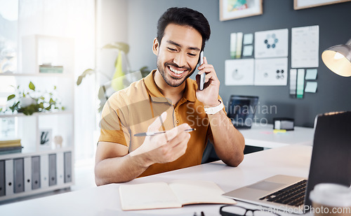 Image of Phone call, happy and strategy with a business man chatting while working at his desk in the office. Mobile, contact and communication with a young male employee chatting or networking for planning