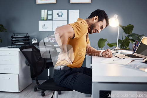 Image of Business man, night and back pain or stress at office desk in a modern workplace . Asian male entrepreneur with injury and health, physical or burnout problem while tired and working late