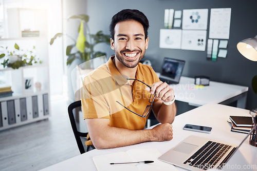 Image of Happy, smile and portrait of a businessman in the office while working on a project with a laptop. Confidence, leadership and professional male employee planning a company report in the workplace.