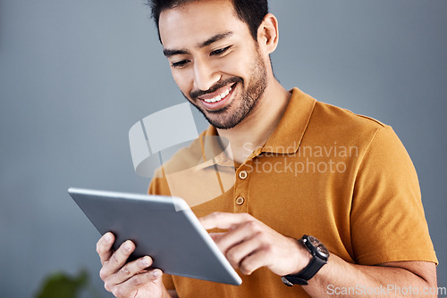 Image of Digital tablet, happy and man typing creative illustration, graphic design sketch or online advertising typography. Creativity, branding agency and Asian designer working on logo development process