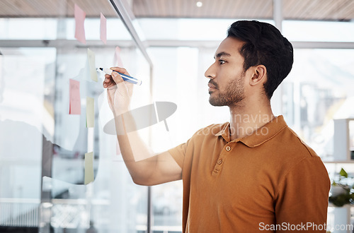 Image of Writing, planning and focused man on glass for project management, moodboard and business priority planner. Asian person brainstorming ideas, job management and sticky notes for solution or reminder