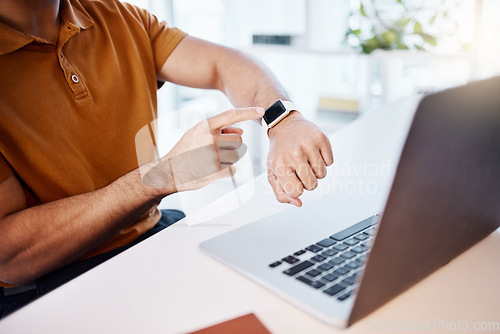 Image of Man, hands and watch by laptop for time, schedule or monitoring heart rate at the office desk. Hand of male looking at wristwatch while working on computer for business deadline, performance or timer