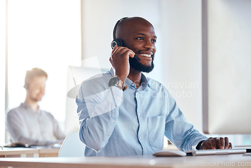 Image of Call center, computer and listening with black man in office for customer service, technical support and advice. Technology, contact us and communication with employee operator in help desk agency