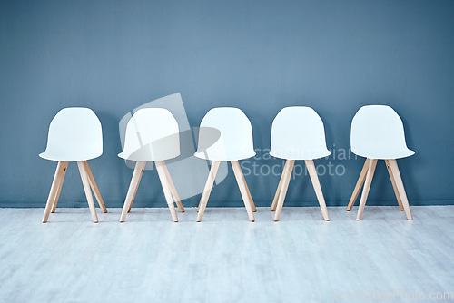 Image of Human resources, hiring and recruitment with a row of chairs in a studio on a gray background waiting area. Interview, room and furniture in an empty or minimalist hr office in a corporate company