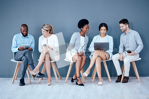 Image of Business people, meeting and waiting room for interview, networking or job opportunity at the office. Diversity and group of employees sitting in row for recruitment process, collaboration or hiring