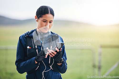 Image of Music, phone and woman in the countryside ready for fitness and exercise with mockup. Sports, training and mobile headphones of a female athlete looking at gps with audio and web radio for workout