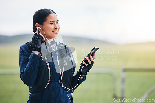 Image of Music, phone and woman smile in the countryside ready for fitness and exercise with mockup. Sports, training and mobile headphones of a female athlete with internet audio and web radio for workout