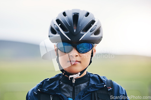 Image of Portrait, cycling or girl athlete in nature for exercise, workout or training for triathlon sports or fitness. Woman cyclist, helmet gear or face of biker on break exercising for cardio endurance