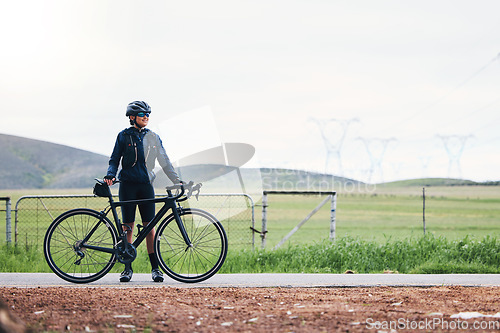 Image of Woman, athlete and bicycle in countryside, mockup on sky and training for triathlon, sports and goals. Female cyclist, bike and fitness gear with motivation, freedom or thinking of cardio performance