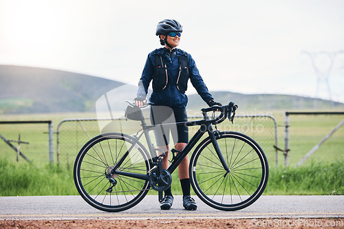 Image of Fitness, bicycle and woman on break from cycling, sports and training in the countryside for morning cardio. Bike, ride and female cyclist relax, smile and happy during workout, exercise and travel