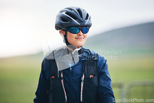 Image of Happy woman, cycling athlete and thinking in nature for exercise, training and triathlon sports. Female cyclist, bike helmet and glasses for fitness gear, motivation and freedom of cardio performance