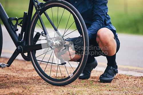 Image of Person, bike and wheel repair outdoor for training, triathlon sports and transportation problem. Closeup of athlete, bicycle and check tire chain for travel safety, cycling maintenance and fixing hub