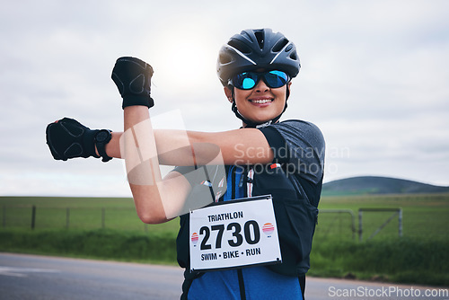 Image of Stretching, triathlon and cycling with woman in road for training, competition and workout. Warm up, fitness and exercise with female cyclist in nature ready for performance, summer and marathon