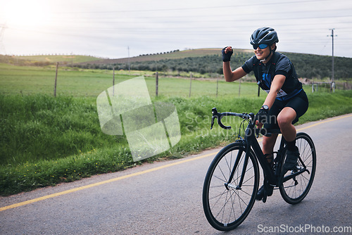 Image of Fitness, win and woman in celebration while cycling in nature with energy for a race, marathon or competition. Sports, workout and female athlete cyclist cheering for cardio exercise on outdoor road.