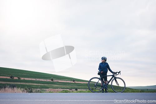 Image of Sports, woman and bicycle in countryside with sky mockup, athlete and thinking of cardio training goals. Female cyclist, bike and fitness with copy space, freedom and cycling performance in triathlon