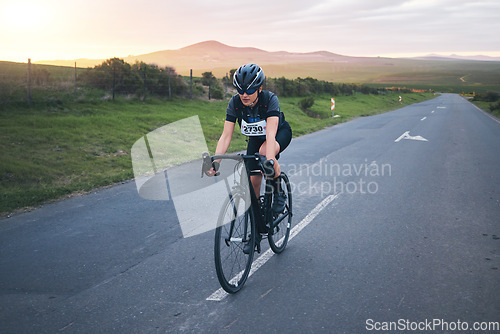 Image of Fitness, cycling and woman athlete on a mountain while training for a race, competition or marathon. Sports, cycle and female cyclist doing a cardio exercise or workout with bicycle in road on a hill