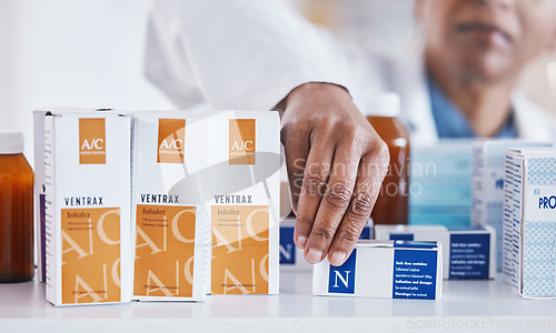 Image of Pharmacist hand, shelf or packing box for stock, inventory or organized store for wellness. Pharmacy business owner, woman and medicine to organise pills for customer experience at retail health shop