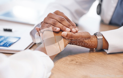 Image of Closeup, holding hands and doctor with support for patient with consulting, listening and empathy at desk. Medic, woman and helping hand for solidarity, care and counselling for health with bad news