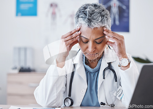 Image of Senior woman, doctor and headache in burnout, stress or anxiety for healthcare at the hospital. Tired elderly female medical professional suffering from bad head pain, migraine or ache at the clinic