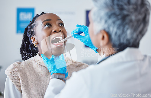 Image of Consultation, doctor and patient with tongue depressor, open mouth pain and healthcare advice at clinic. Black woman consulting medical professional, health care check and tonsil exam at hospital.