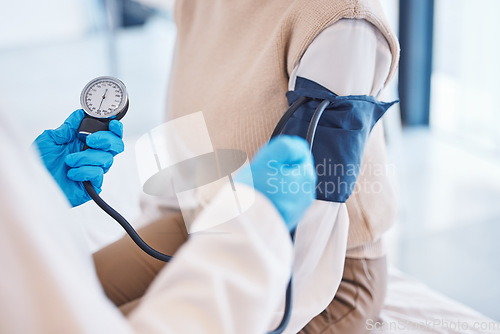 Image of Hands, doctor and patient with blood pressure test and healthcare advice at clinic. Woman consulting medical professional, health care check and insurance, info and help with wellness at hospital.