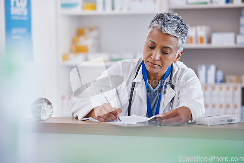 Image of Woman, doctor and writing on clipboard at pharmacy for healthcare prescription, diagnosis or inventory at counter. Female medical professional taking notes on pharmaceutical products at the clinic