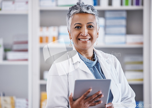 Image of Senior woman, pharmacist and tablet in portrait for healthcare, medicine or entrepreneurship at store. Female pharma expert, mobile touchscreen or excited for small business, service or wellness shop