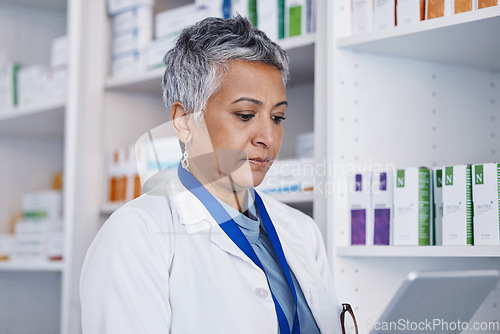 Image of Senior woman, pharmacist and reading tablet for healthcare, medicine or inventory check at store on app. Female pharma expert, mobile touchscreen and focus for online order, service or prescription