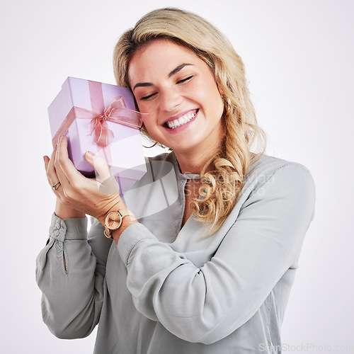 Image of Happy, person and woman with a gift, surprise and special event with a winner against studio background. Female model, smile and lady with a present, celebration and excited with parcel and package