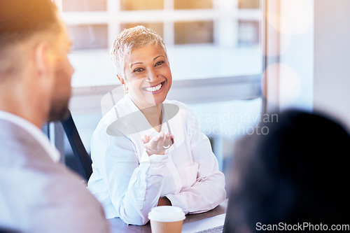 Image of Senior business woman, meeting and smile in discussion, seminar and happy for team building in office. Female manager, leader and talking to staff with happiness for workshop, planning or strategy