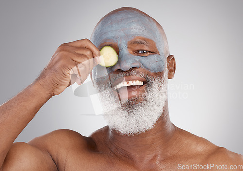 Image of Facial mask, cucumber and black man with smile in portrait, beauty and skincare isolated on studio background. Happy senior male, cosmetic care and healthy skin, anti aging cosmetics routine for face