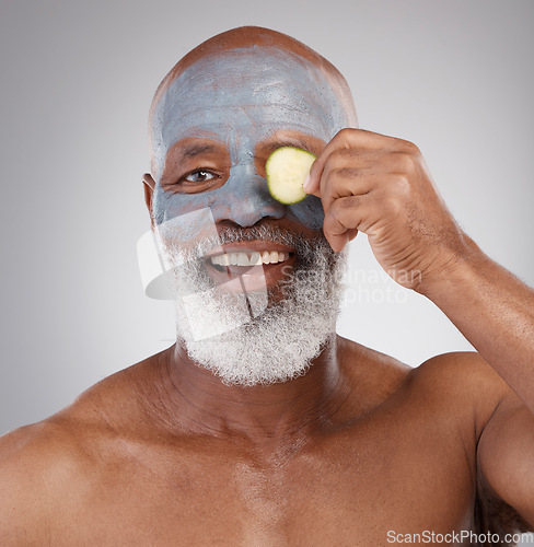 Image of Face mask, cucumber and black man with smile in portrait, beauty and skincare isolated on studio background. Happy senior male, cosmetics and healthy skin, anti aging cosmetic routine with facial