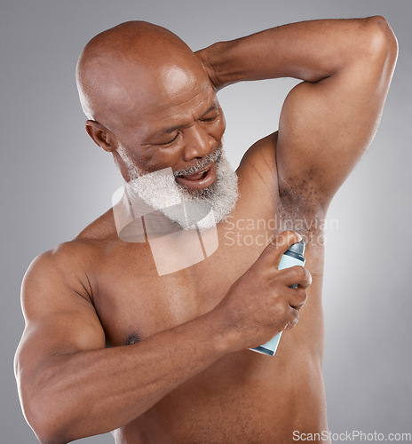 Image of Senior man with spray armpit, deodorant and grooming, beauty and cosmetic fragrance isolated on studio background. Skin, cosmetics product and perfume cologne with clean male person and hygiene