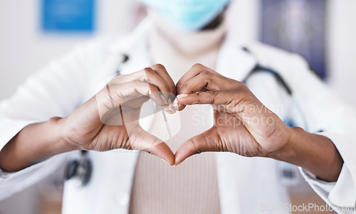 Image of Doctor, hands and heart sign for healthcare or love and care for career as medical worker in hospital. Hand gesture of woman to show support, hope or emoji for charity, cardiology or health insurance