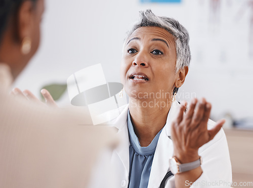 Image of Senior woman, doctor and consultation with question, listen or conversation for healthcare, wellness or advice. Elderly medic, consulting patient and talking in hospital, clinic or listen for problem