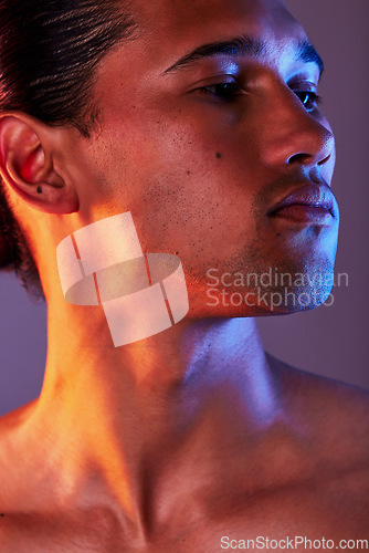 Image of Beauty, neon and face of man in studio for skincare, self care and facial treatment on purple background. Creative aesthetic, glow and profile of male model for healthy skin, wellness and confidence