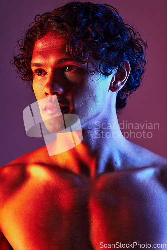 Image of Light, shirtless or man in studio with art lighting and thinking with self care and neon. Focus, isolated and dark background of an attractive male model with artistic, creative and wellness fitness