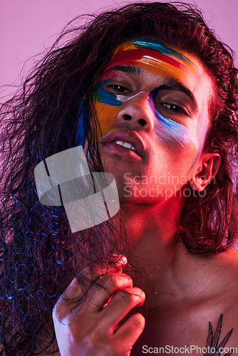 Image of Creative, face paint and art with portrait of man in studio for beauty, self love and designer. Fantasy, neon and light with male model on pink background for makeup, colours and cosmetics