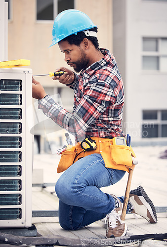 Image of Black man, electrician and maintenance with engineer and ac repair with handyman working with tools on roof. Fix air conditioner, male technician with screwdriver and power generator with service