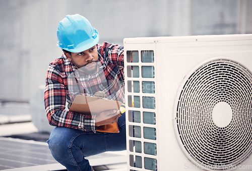 Image of Black man, electrician with clipboard for air conditioner inspection, handyman working on rooftop with focus. Maintenance check, AC repair and male technician with power generator and service