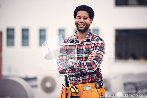 Image of Construction worker, portrait and man on a building roof for architecture and property management. Smile, happiness and industrial designer with arms crossed and sustainable energy with motivation