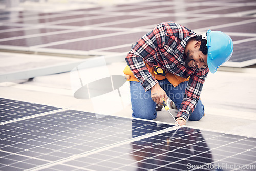 Image of Solar panel, repair and engineering man on rooftop with tools, energy saving and sustainable power maintenance. African person, electrician contractor or technician working on photovoltaic generator