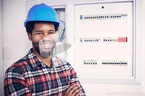 Image of Black man in portrait, technician and electricity fuse box, check power supply with maintenance on main circuit breaker. Engineer, electrician and male worker with smile, handyman and electrical fix