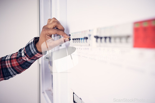 Image of Man, hand and electrician with electricity fuse box, check power supply with maintenance on main circuit breaker switch. Engineer, technician and male worker with handyman and electrical fix