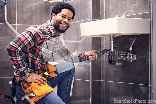 Image of Portrait, man and plumber with smile, maintenance and installation with home repairs. Face, Nigerian male employee or worker with tools, fixing pipes and sink with handyman, contractor and renovation
