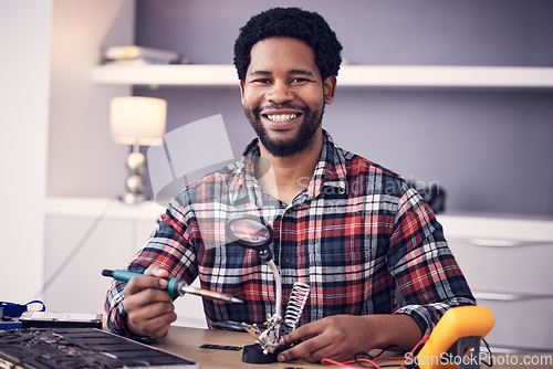 Image of Technician portrait, man and fixing electronics of computer hardware, soldering iron tools or tech repair. Maintenance, magnifying glass or electrical fix for happy African male working on technology