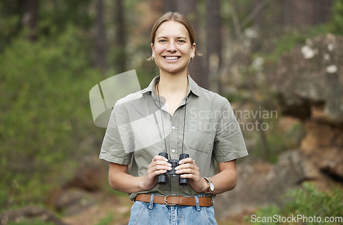 Image of Binocular, forest and portrait of happy woman hiking for nature journey, jungle adventure and travel in outdoor explore. Face of a young person birdwatching and trekking in eco friendly green woods