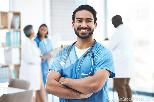 Image of Medical, arms crossed doctor with portrait of man for healthcare, surgery and happy. Smile, medicine and confident with male nurse standing in hospital for wellness, cardiology and expert